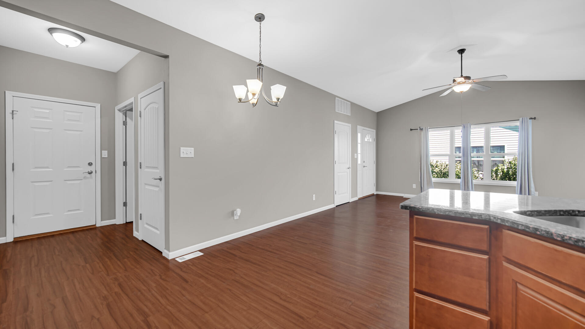 3889-91 Stadium Street Portage, IN 46368 - Photo 10 of 23 a view of an empty room with wooden floor and a window
