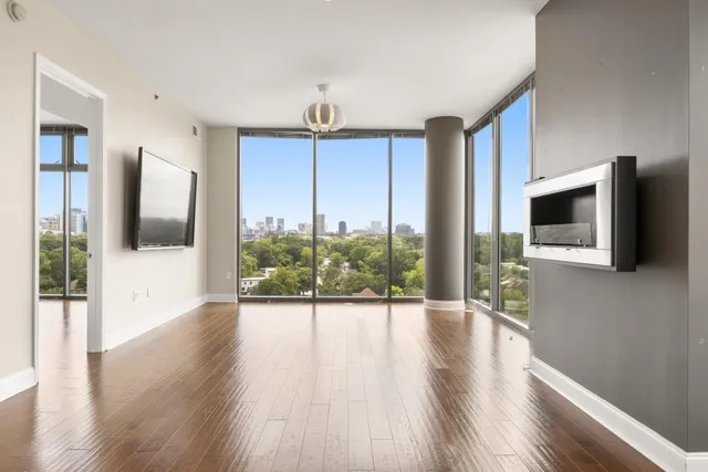 a view of a living room a flat screen tv and floor to ceiling window