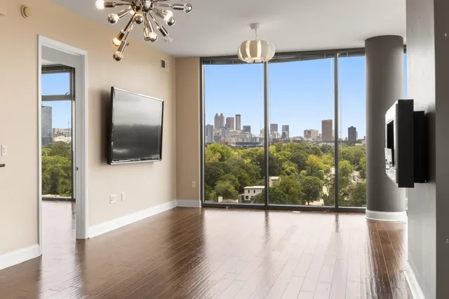 a view of a living room a window and wooden floor
