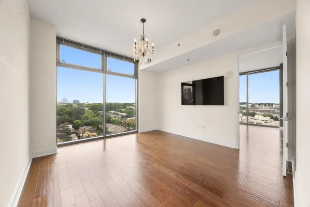 a view of a livingroom with wooden floor and a ceiling fan