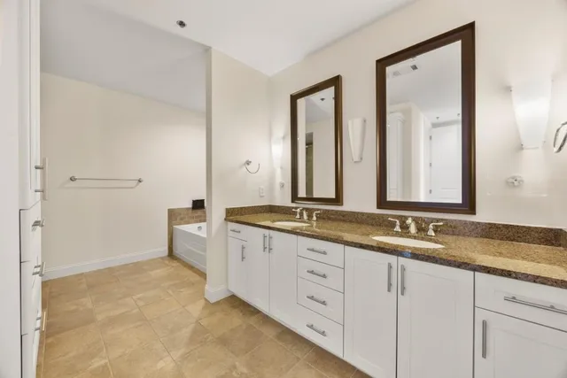 a bathroom with double sink and a mirror