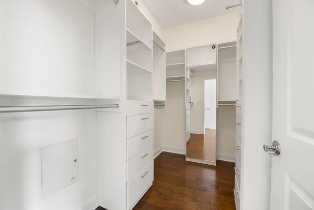 a view of walk in closet with white walls