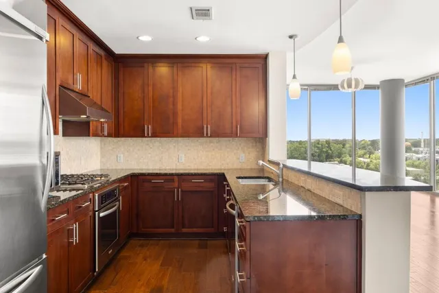 a kitchen with a sink stove and cabinets