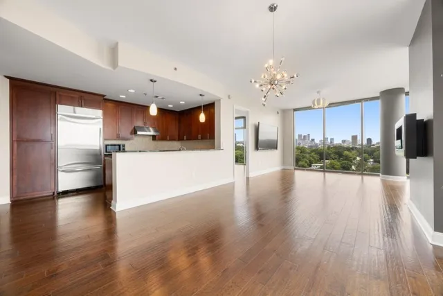 a view of a kitchen and an empty room with a kitchen