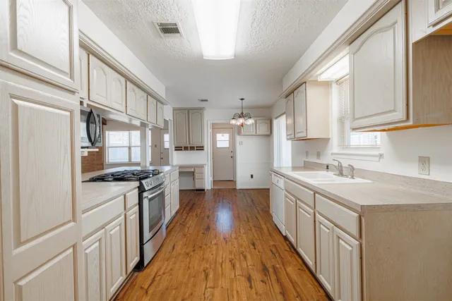 a very nice looking room with wooden floor and windows
