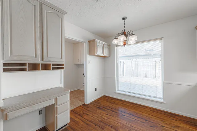 a view of empty room with wooden floor and fireplace