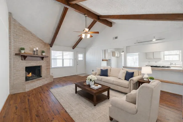 a view of empty room with wooden floor and fireplace