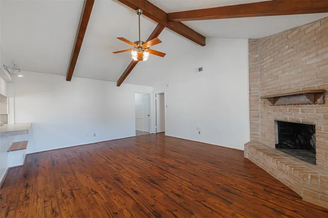 a view of a room with a ceiling fan and a window