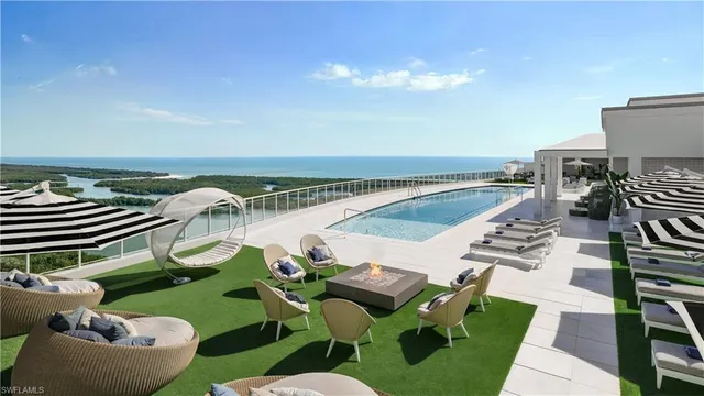 a view of a swimming pool with lounge chairs
