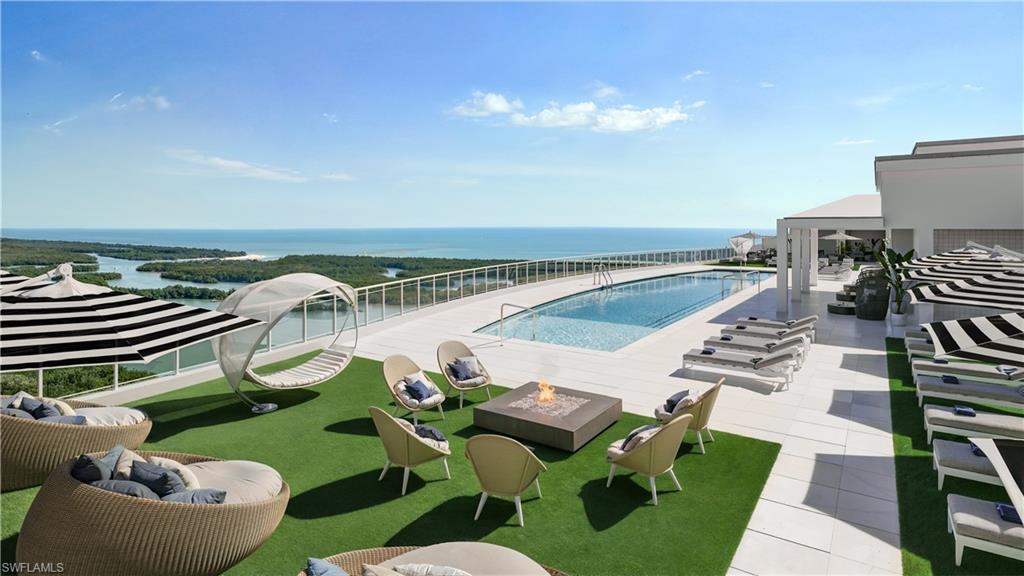 13955 Old Coast Road, Unit 804 Naples, FL 34110 - Photo 3 of 14 a view of a swimming pool with lounge chairs