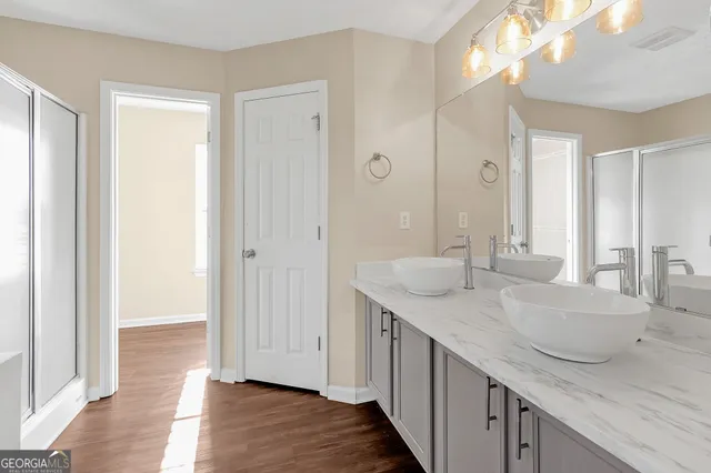 a bathroom with a granite countertop sink and a mirror