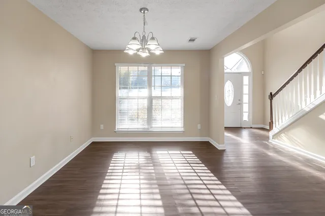 a view of a room with windows and chandelier