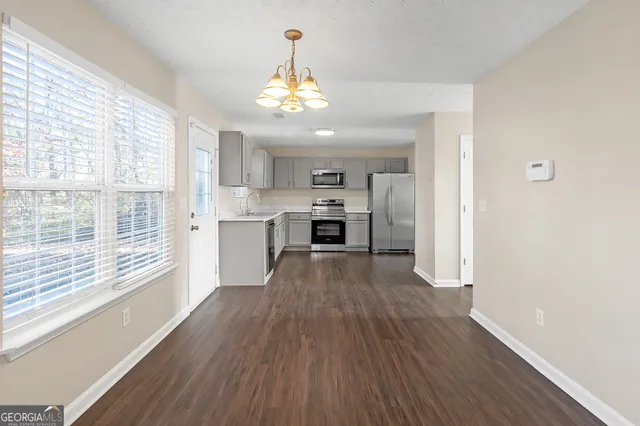 a view of a kitchen with wooden floor and a kitchen
