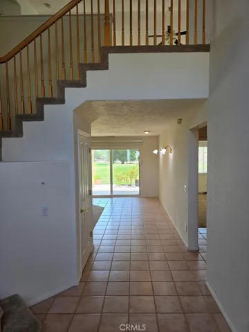 en empty room with fan mirror and window
