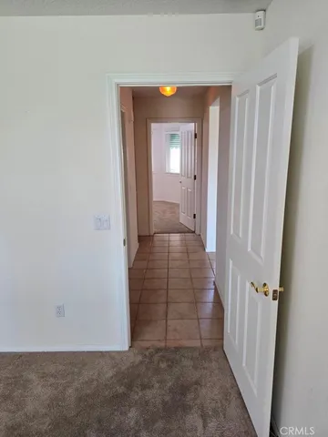 an empty room with windows and fireplace