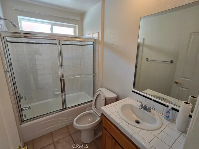 a kitchen with stainless steel appliances kitchen island granite countertop a table chairs in it and wooden floors