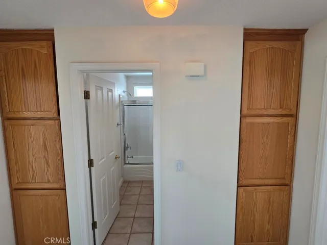 a kitchen with a stove a refrigerator a sink dishwasher with a dining table and chair