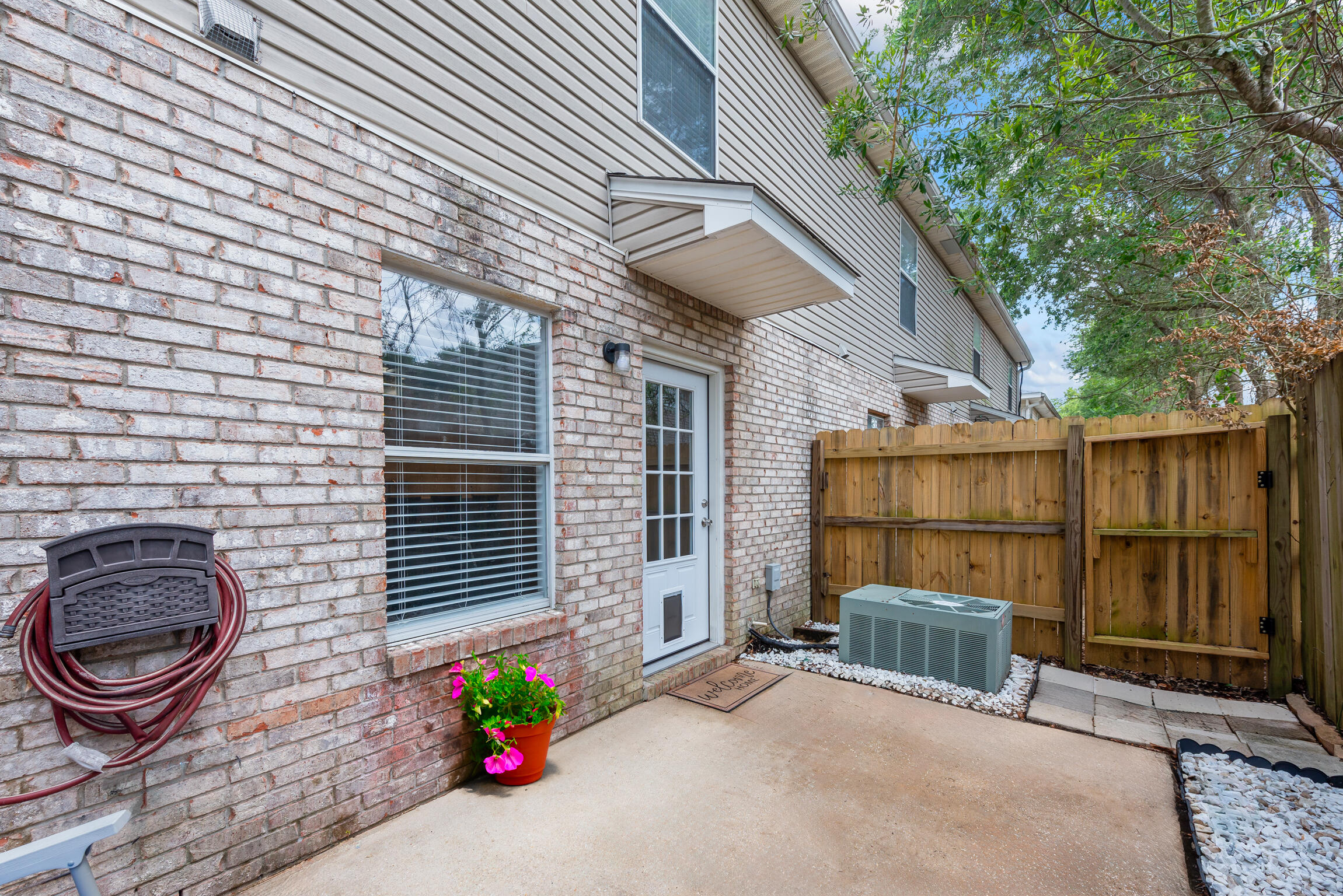 498 Keystone Road Mary Esther, FL 32569 - Photo 16 of 21 a view of a backyard with door and outdoor seating
