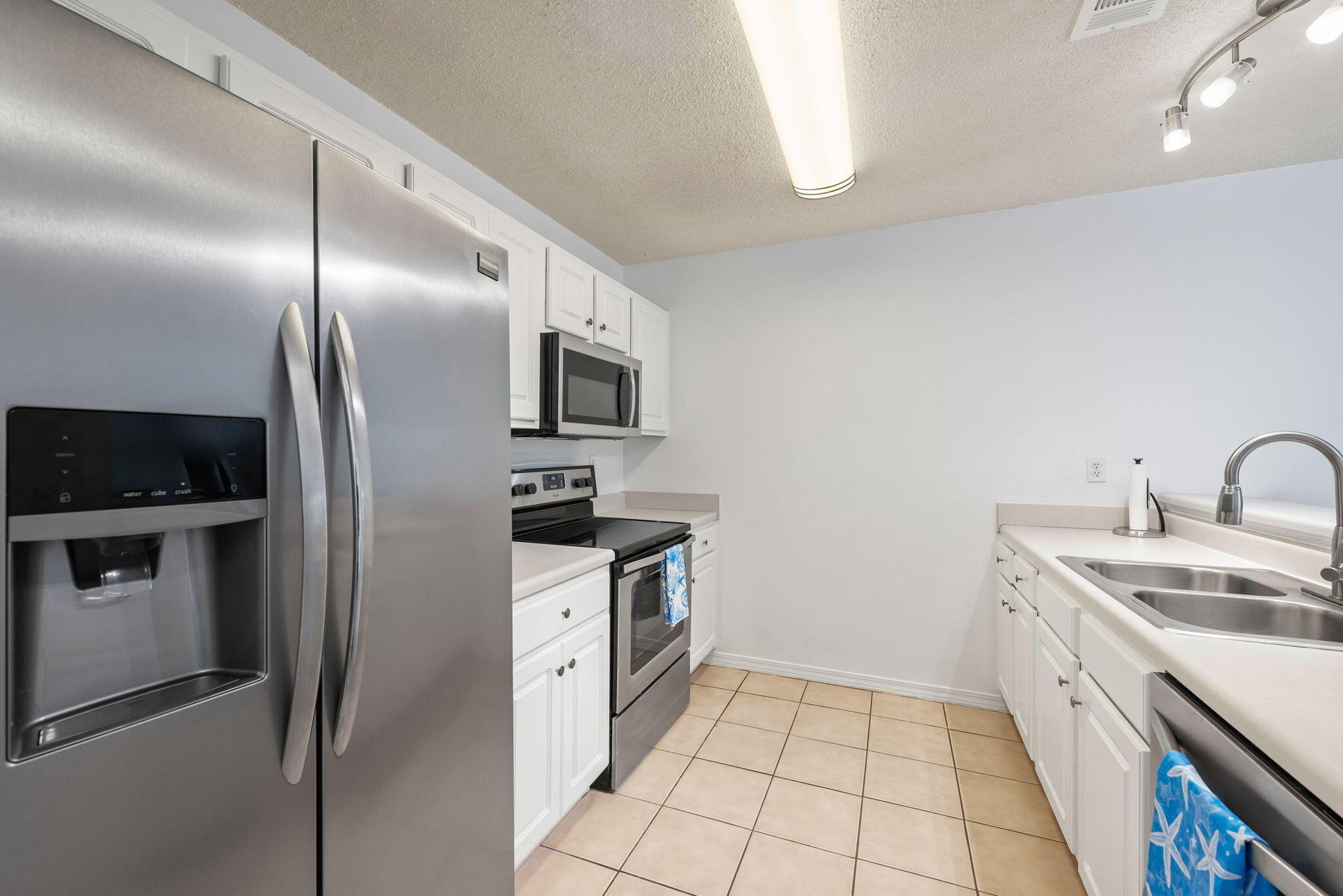 498 Keystone Road Mary Esther, FL 32569 - Photo 7 of 21 a kitchen with granite countertop a refrigerator and a sink