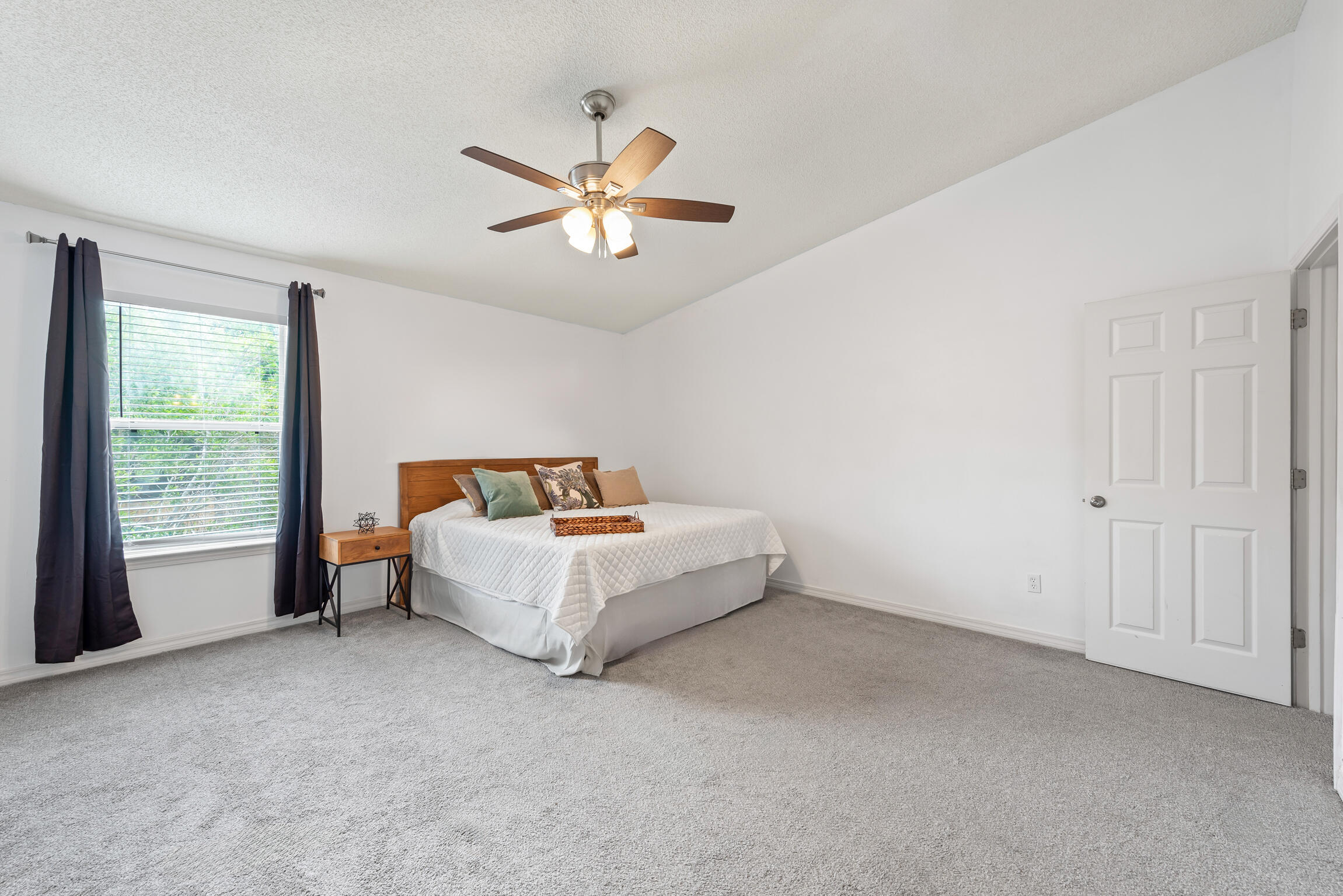 498 Keystone Road Mary Esther, FL 32569 - Photo 9 of 21 a spacious bedroom with a bed and a chandelier