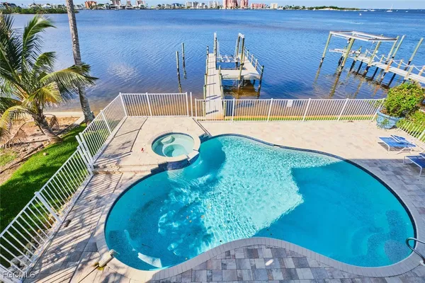 a view of a swimming pool with a yard
