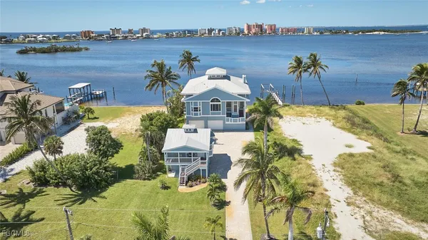 an aerial view of a house with a lake view