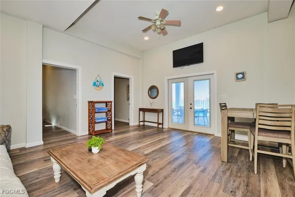 a living room with furniture a flat screen tv and a table