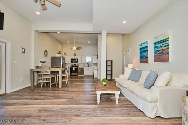 a living room with furniture and wooden floor