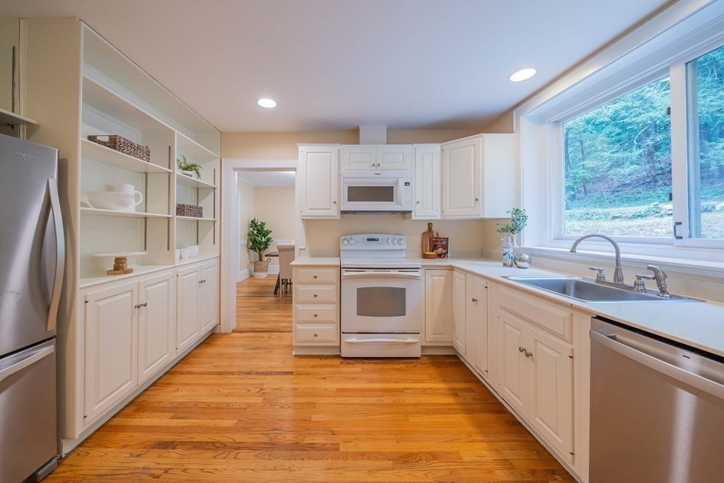 11 Wachusett Drive Lexington, MA 02421 - Photo 18 of 42 a kitchen with granite countertop white cabinets and white appliances