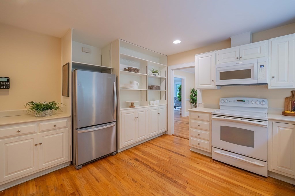 11 Wachusett Drive Lexington, MA 02421 - Photo 22 of 42 a kitchen with white cabinets and stainless steel appliances