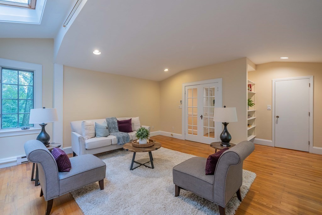 11 Wachusett Drive Lexington, MA 02421 - Photo 23 of 42 a living room with furniture and a wooden floor