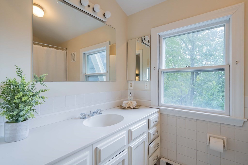 11 Wachusett Drive Lexington, MA 02421 - Photo 32 of 42 a bathroom with a sink and a mirror