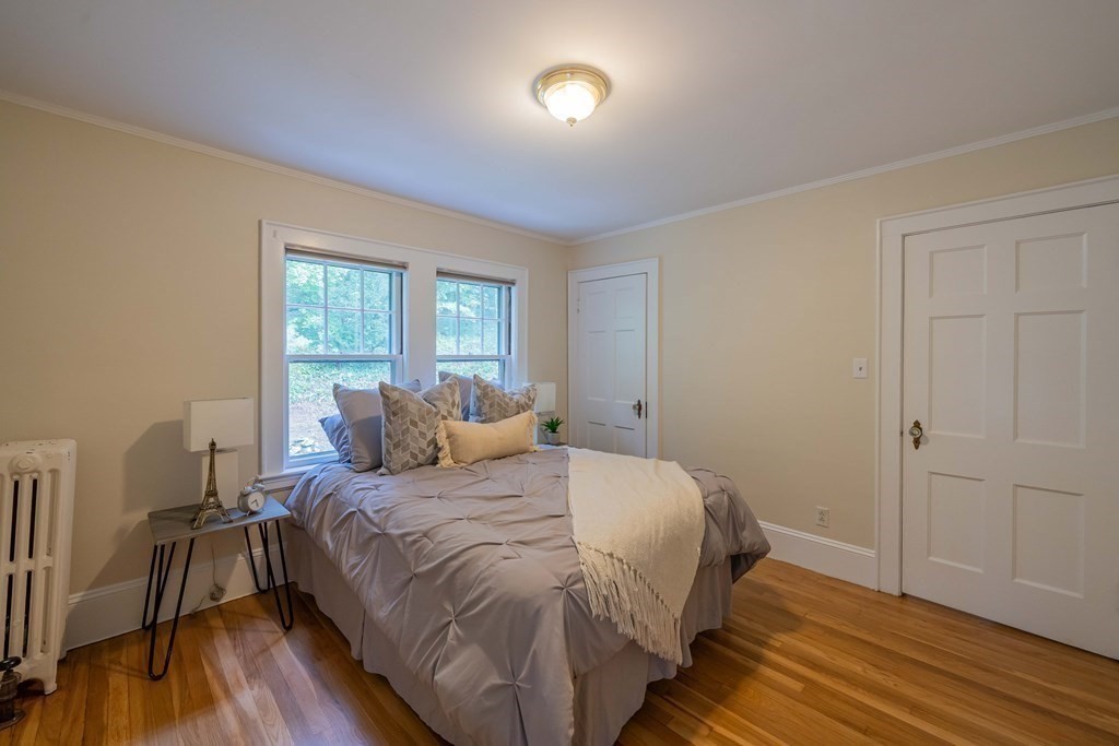 11 Wachusett Drive Lexington, MA 02421 - Photo 37 of 42 a bedroom with a bed and a wooden floor