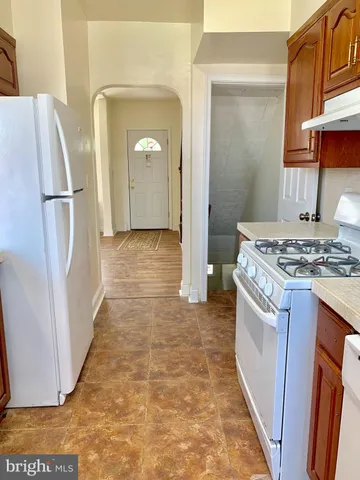 a kitchen with refrigerator a stove a sink and dishwasher