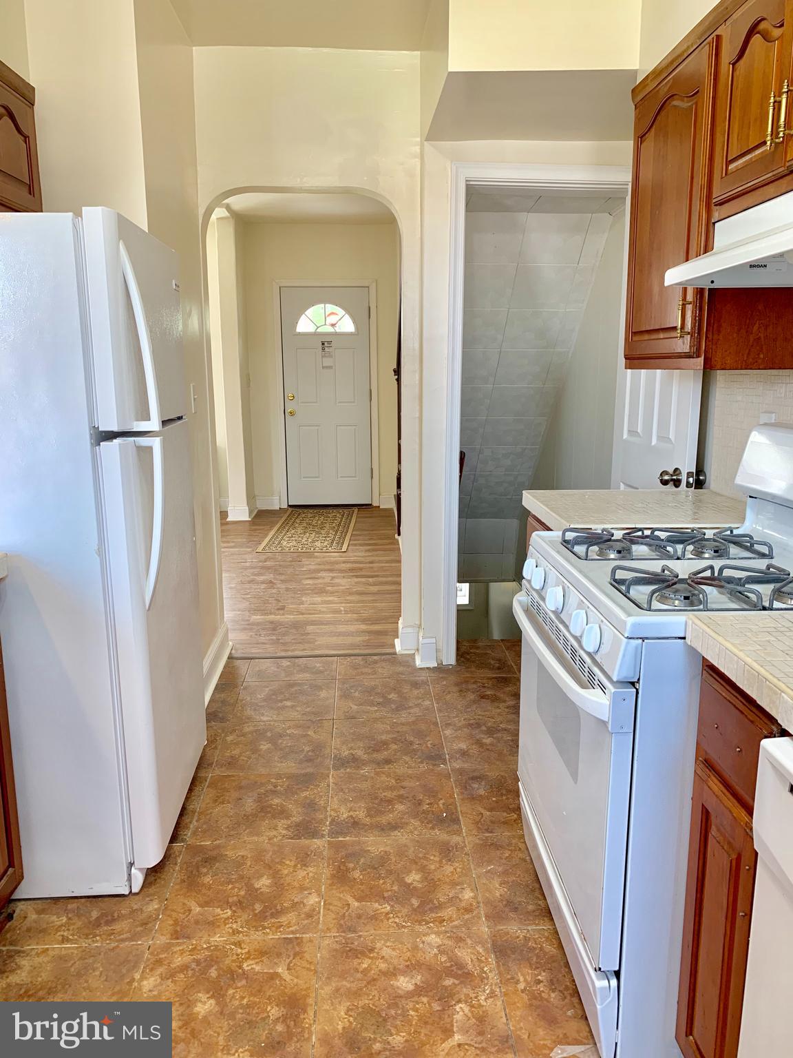 3542 Lyndale Avenue Baltimore, MD 21213 - Photo 6 of 12 a kitchen with refrigerator a stove a sink and dishwasher