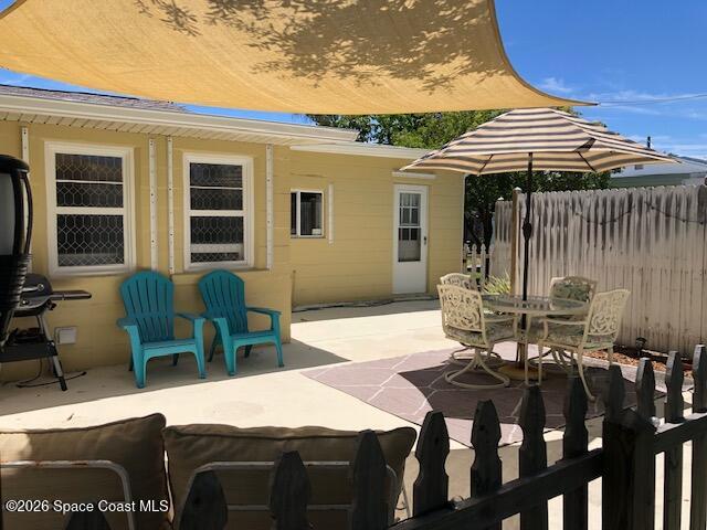 145 Atlantic Avenue Indialantic, FL 32903 - Photo 11 of 13 a patio with table and chairs
