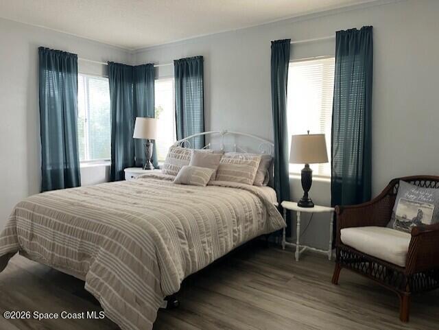 145 Atlantic Avenue Indialantic, FL 32903 - Photo 2 of 13 a bedroom with a bed and wooden floor