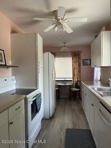 a kitchen with a stove a sink and a refrigerator