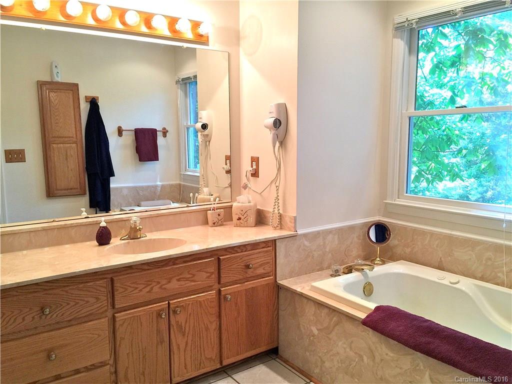 660 Edwards Cove Road, Unit 1 Waynesville, NC 28786 - Photo 13 of 24 a bathroom with a double vanity sink and mirror