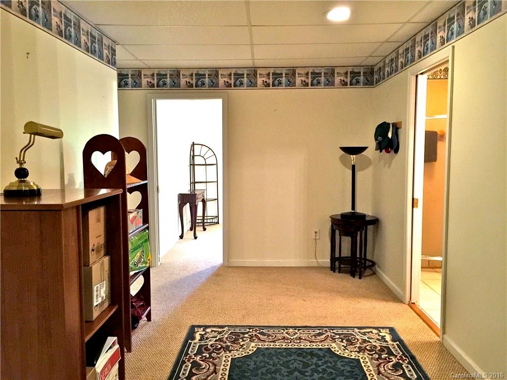 660 Edwards Cove Road, Unit 1 Waynesville, NC 28786 - Photo 17 of 24 a view of a hallway with wooden floor and furniture