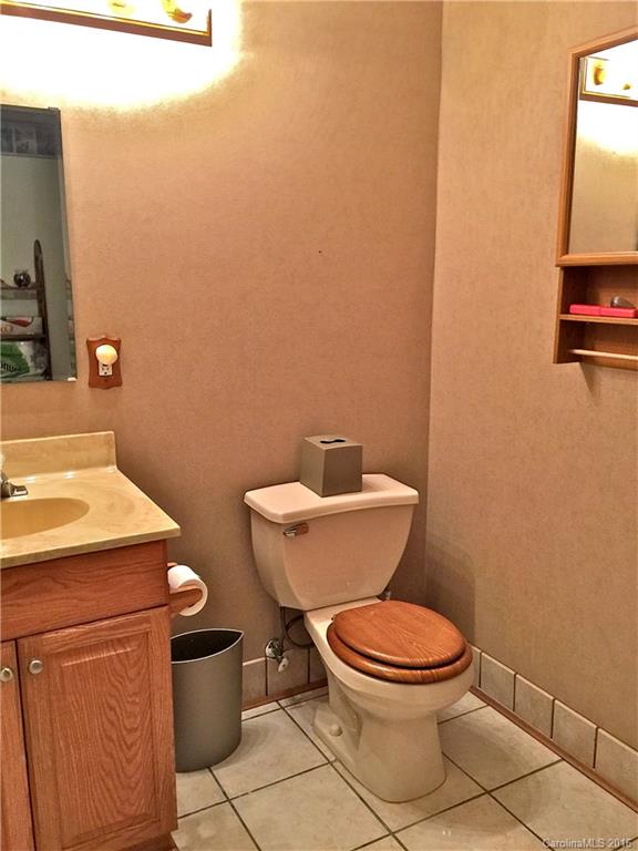 660 Edwards Cove Road, Unit 1 Waynesville, NC 28786 - Photo 19 of 24 a white toilet sitting next to a bathroom sink