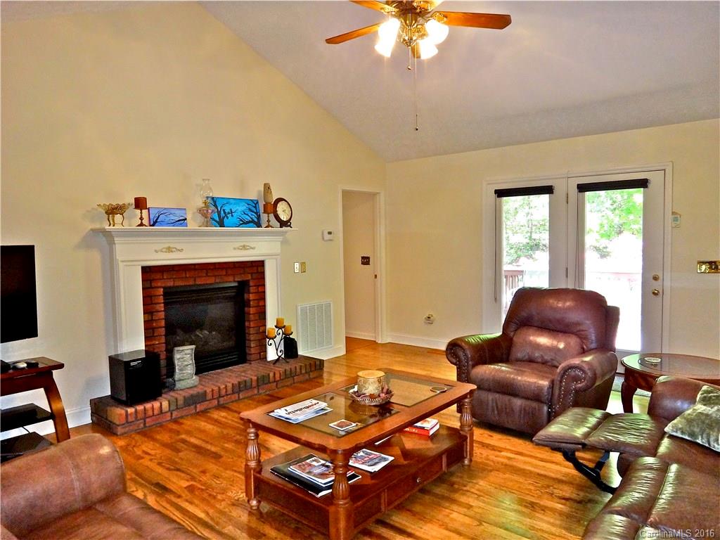 660 Edwards Cove Road, Unit 1 Waynesville, NC 28786 - Photo 4 of 24 a living room with furniture and a fireplace