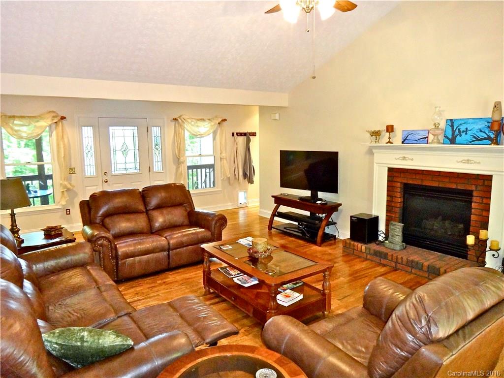 660 Edwards Cove Road, Unit 1 Waynesville, NC 28786 - Photo 5 of 24 a living room with furniture a fireplace and a flat screen tv
