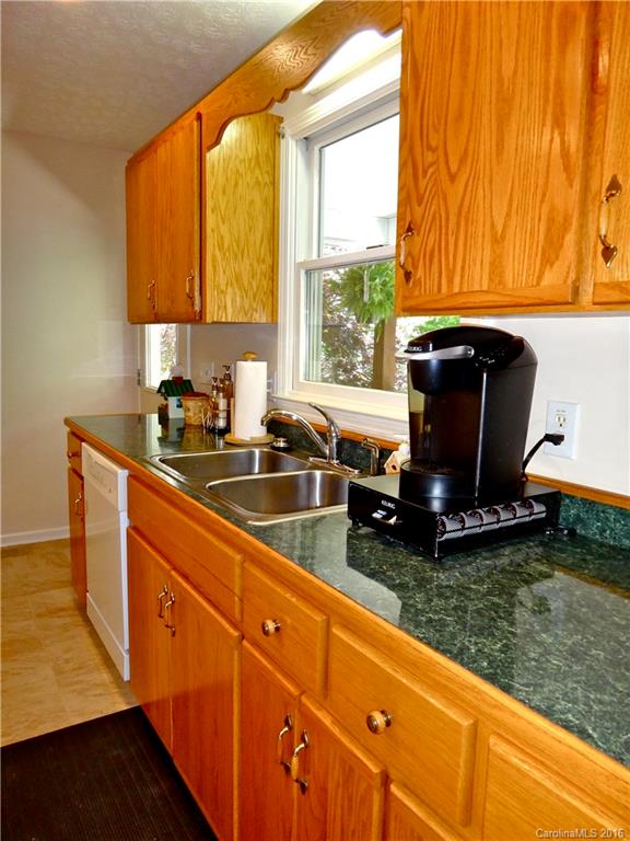 660 Edwards Cove Road, Unit 1 Waynesville, NC 28786 - Photo 7 of 24 a kitchen with a sink a counter top space and a window