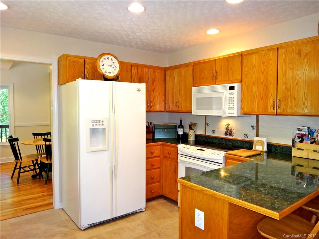 660 Edwards Cove Road, Unit 1 Waynesville, NC 28786 - Photo 8 of 24 a kitchen with stainless steel appliances granite countertop a refrigerator stove top oven and sink