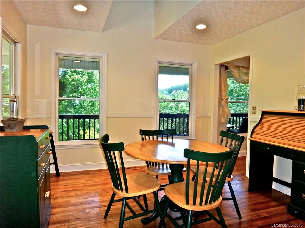 660 Edwards Cove Road, Unit 1 Waynesville, NC 28786 - Photo 9 of 24 a dining room with furniture and wooden floor