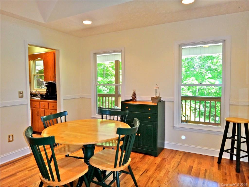 660 Edwards Cove Road, Unit 1 Waynesville, NC 28786 - Photo 10 of 24 a dining room with furniture and a floor to ceiling window