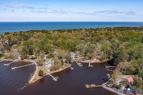 a front view of a house with garden and sitting area