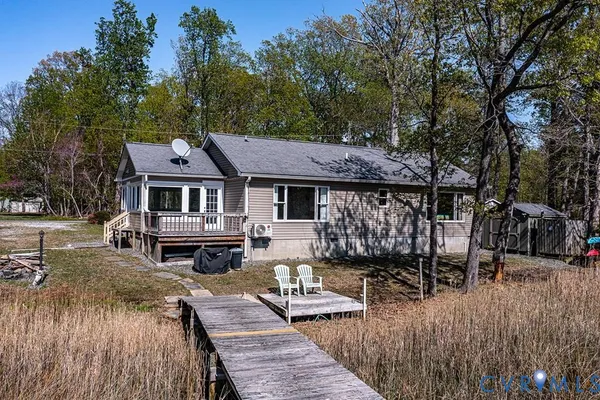 a view of a patio with table and chairs with wooden floor and fence