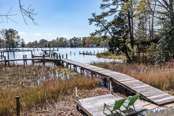 a view of a swimming pool with lawn chairs under an umbrella